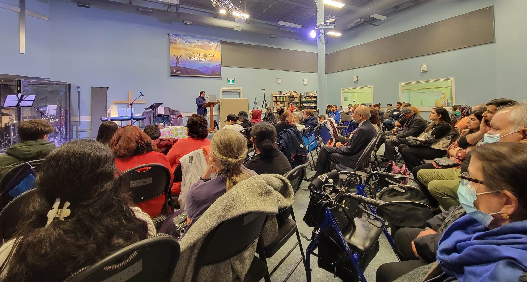 Adib speaking to the congregation at the Afghan Church's 2023 Easter service.