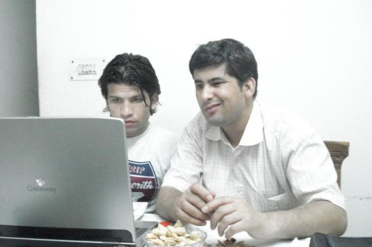 Adib and Obed working together on a computer when they were in India