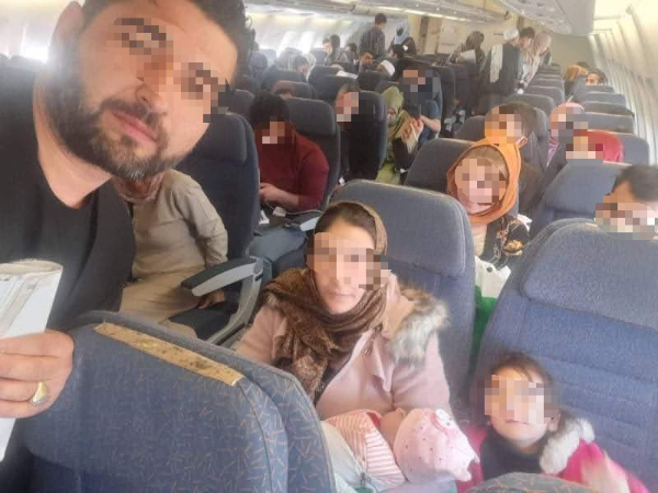 Refugees on a plane headed towards a refugee camp